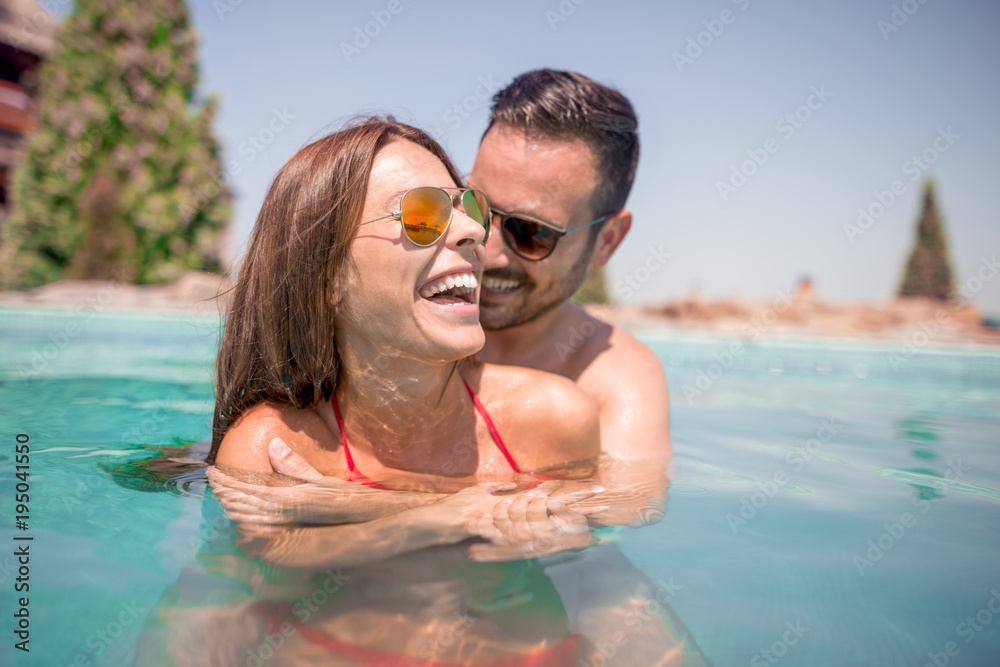 Young couple having fun in the water.