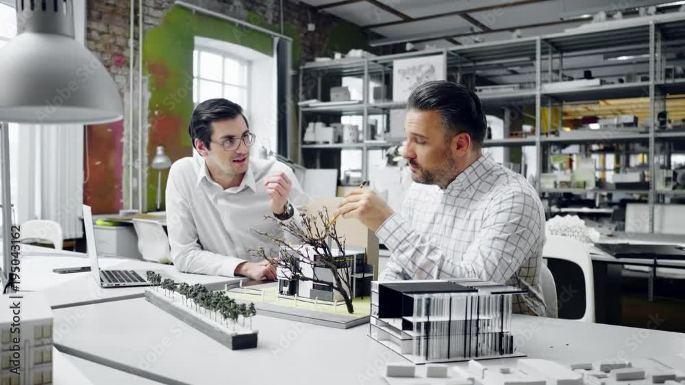 Two men working in design and engineering architecture office. Two men working in design and engineering architecture office.