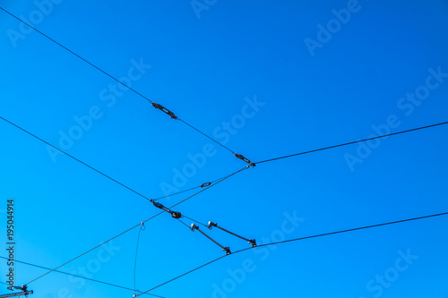 Railroad overhead lines against clear blue sky Contact wire