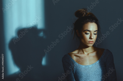 Portrait of a young woman in the room next to the window