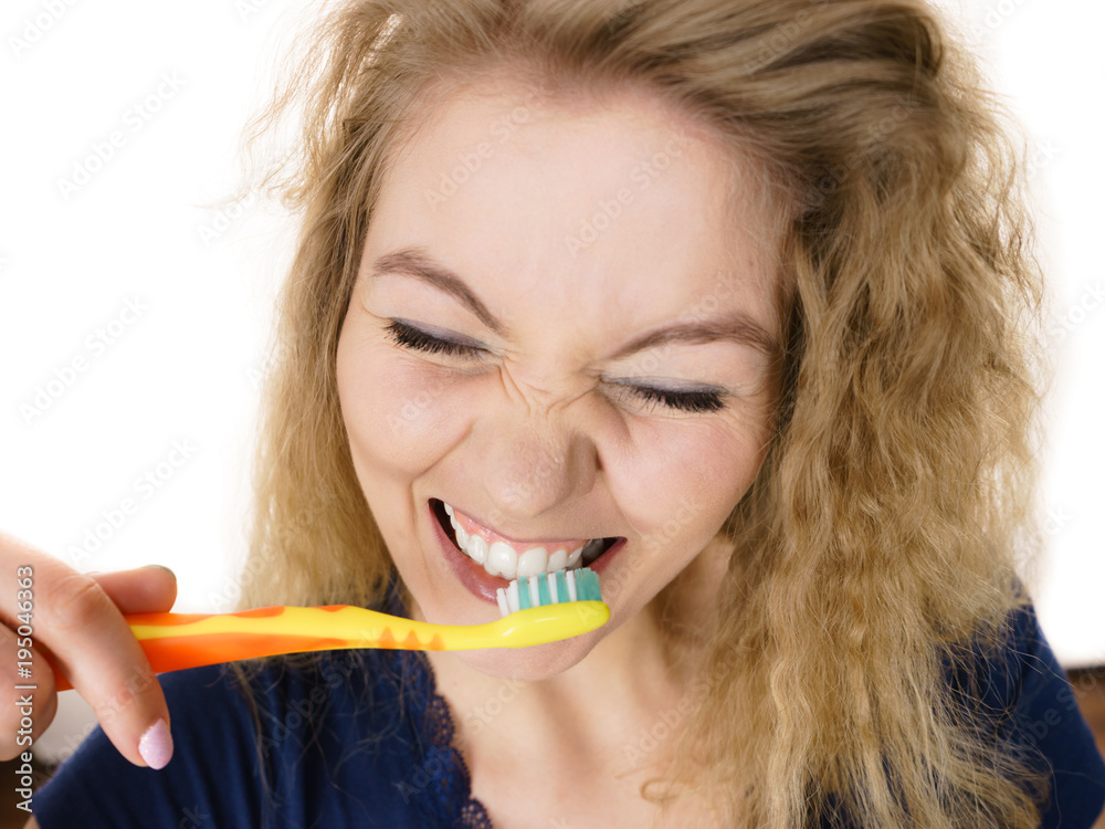 Happy positive woman brushing teeth, isolated Happy positive woman brushing teeth, isolated