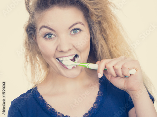 Woman brushing cleaning teeth