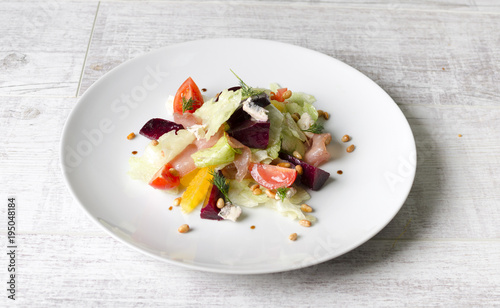 Salad of baked beet with fruits and raw meat