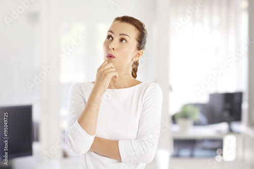 She looks surprised. Portrait shot of a young businesswoman looking surprised while standing at the office. 