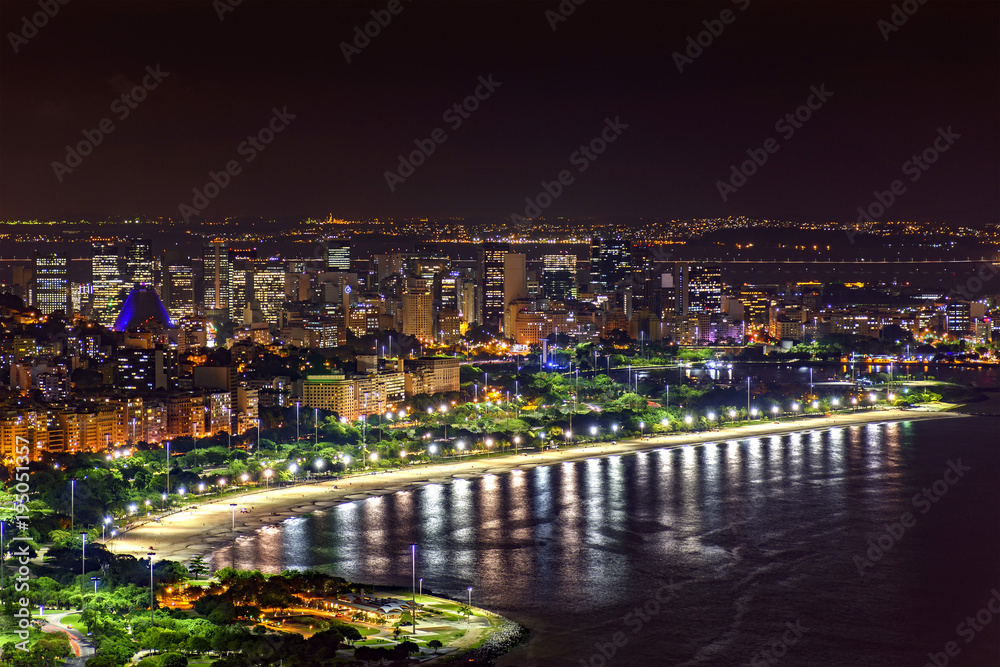 Night view of the top of the Rio de Janeiro downtown with city lights, buildings, beach and streets on a summer night