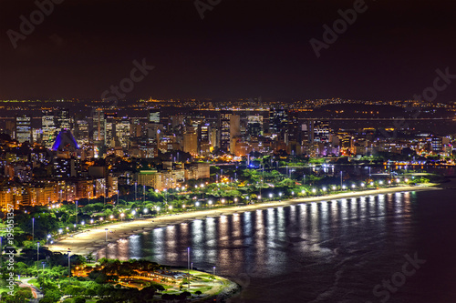 Night view of the top of the Rio de Janeiro downtown with city lights, buildings, beach and streets on a summer night