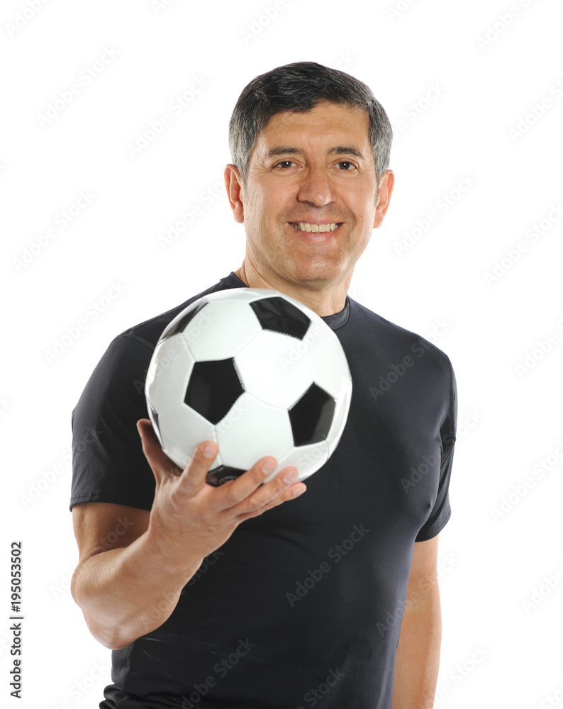 Mature man holding a soccer ball