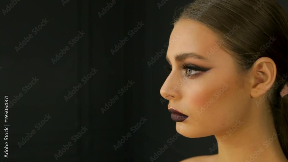 Portrait of a girl with dark lipstick on a black background Portrait of a girl with dark lipstick on a black background