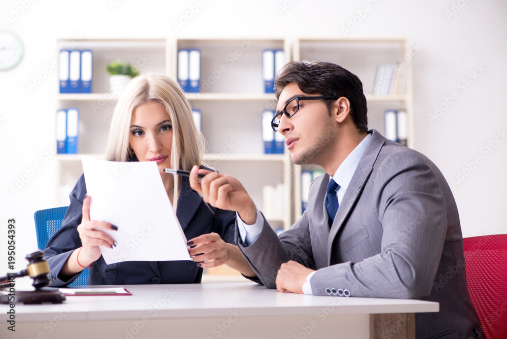 Lawyer discussing legal case with client Lawyer discussing legal case with client