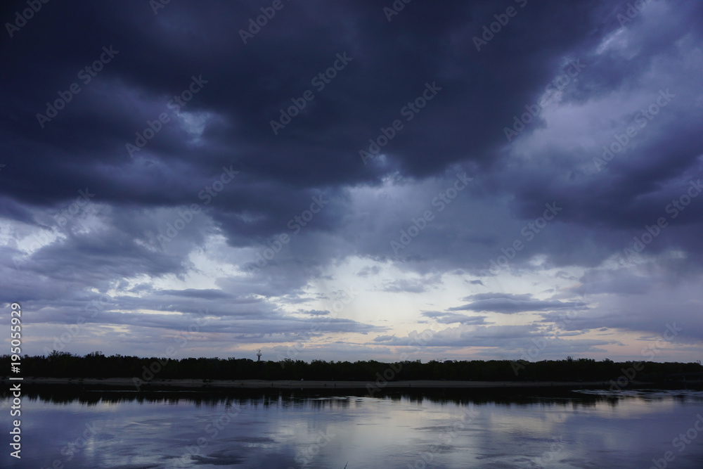 Landscape with forest and amazing sunset blue clouds reflected in river Dnieper, Kiev, Ukraine. 