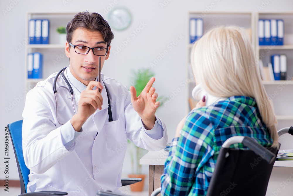 Fototapeta premium Disabled woman in wheel chair visiting man doctor