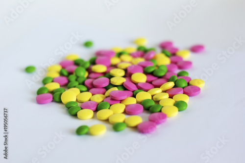  varicoloured drugs scattered on the light surface