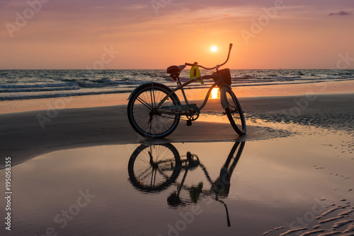 Sun set time with the bicycle on the beach