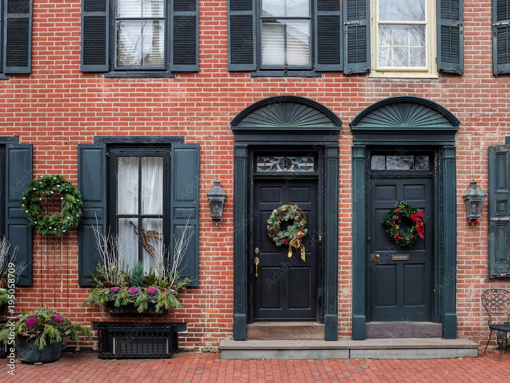 Christmas decorations hung on the doors of town houses 