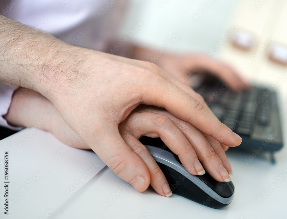 Sexual harassment at work. Man touching secretary's hand. Sexual harassment at work. Man touching secretary's hand.