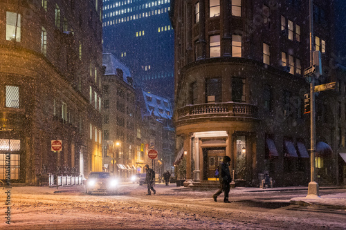 People cross the street in New York City during a snow storm