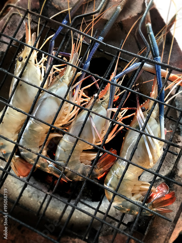 Grilling the river shrimp with hot charcoal.