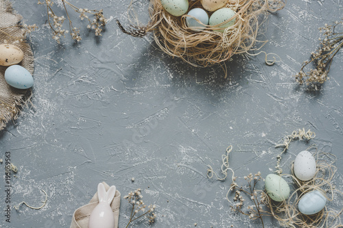 Easter composition. Easter eggs with easter decoration, top view. Copy space
