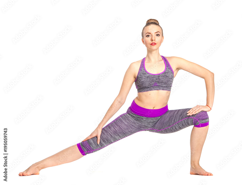 Young attractive woman practicing yoga, stretching in Virabhadrasana I exercise, Warrior one pose, working out, wearing sportswear, indoor full length image, white background Young attractive woman practicing yoga, stretching in Virabhadrasana I exercise, Warrior one pose, working out, wearing sportswear, indoor full length image, white background