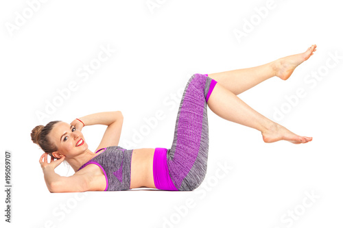 Fototapeta Naklejka Na Ścianę i Meble -  Women doing yoga perform Lying on the back makes exercises for the press. Yoga allows them to develop flexibility and strengthen muscles
