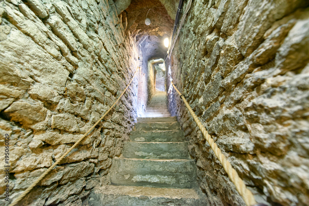 Narrow steep stairs of stone inside a medieval building