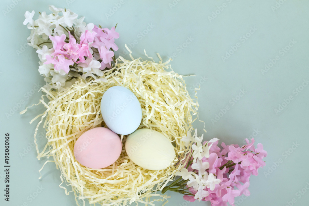 Easter cake and colorful eggs in the nest with Easter flowers Holy Christian holiday spring