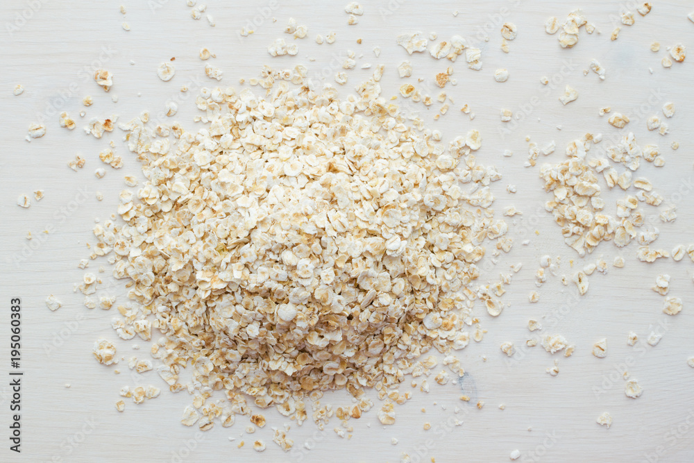 heap of rolled oats on a white background heap of rolled oats on a white background
