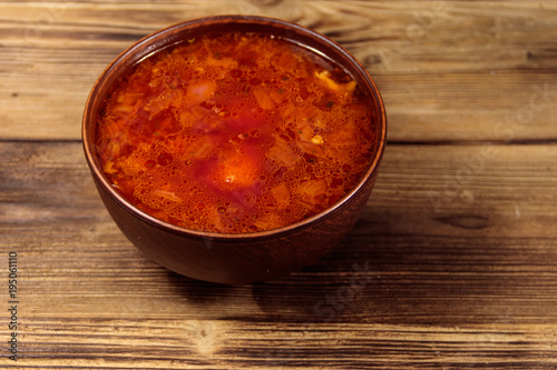 Ukrainian and Russian traditional beetroot soup - borscht on wooden table