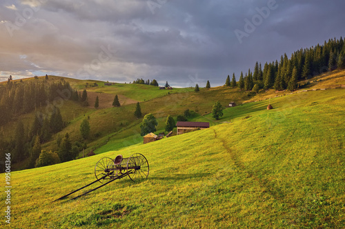 hay stack on the grassy meadow in mountain. beautiful countryside landscape under the blue sky © Ryzhkov Oleksandr