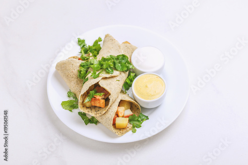 Vegetarian masala dosa with potato, chutney and sambar sauces.