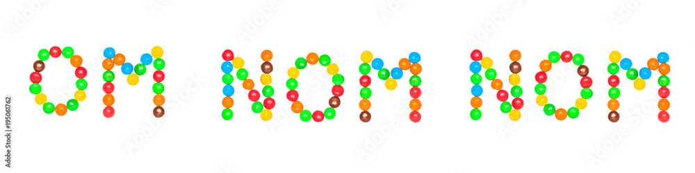 The text OM NOM NOM is written by sweet colorful chocolate candy isolated on white background