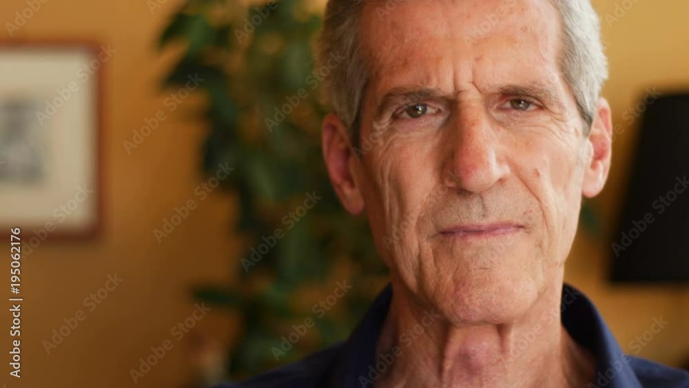 Realxed pensive old man looking at camera- close up