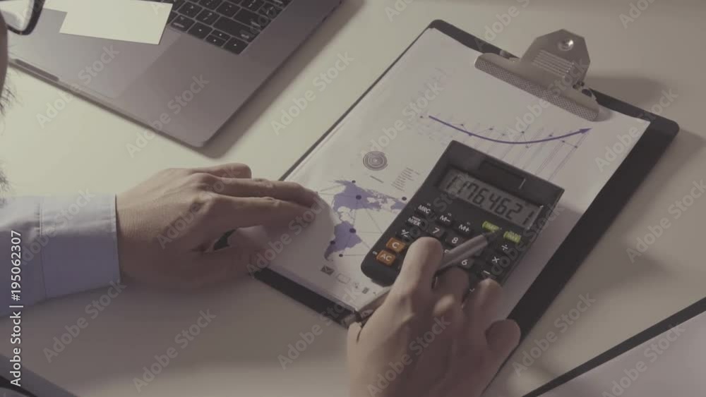 businessman hand working with finances about cost and calculator and laptop with mobile phone on withe desk in modern office
businessman hand working with finances about cost and calculator and laptop with mobile phone on withe desk in modern office