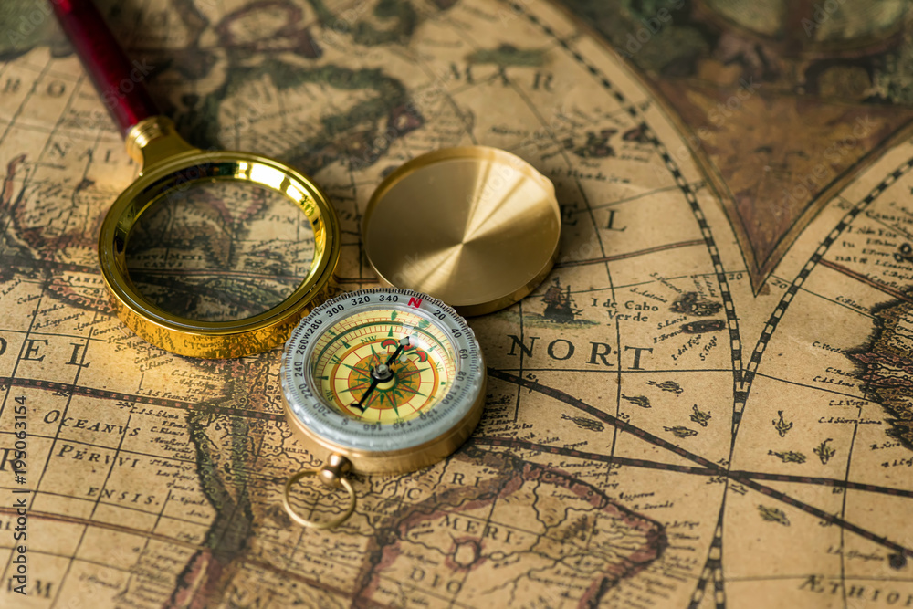 Retro compass with old map and magnifier Retro compass with old map and magnifier