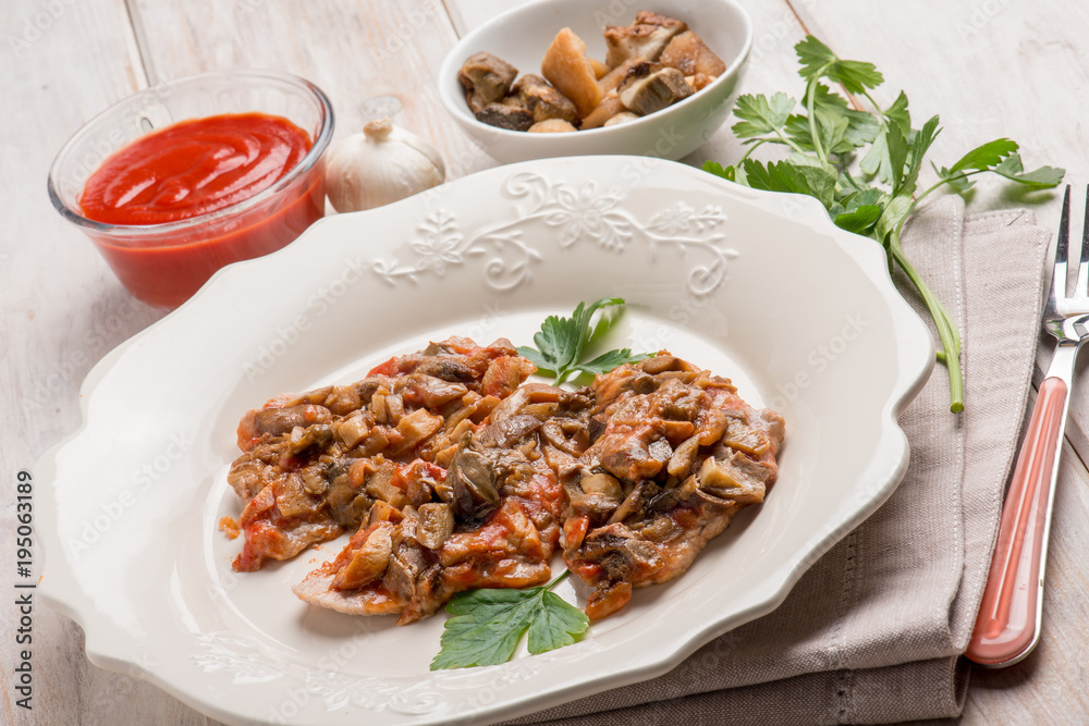 veal escalope with boletus and tomatoes sauce