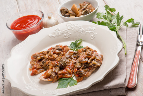 veal escalope with boletus and tomatoes sauce
