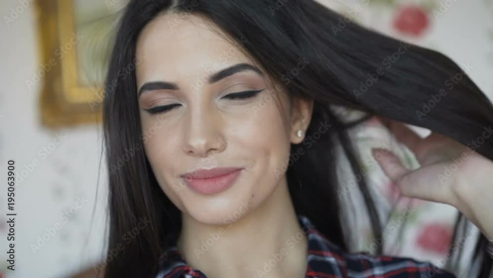 Smart brunette has relax on bed and smiles at camera Smart brunette has relax on bed and smiles at camera