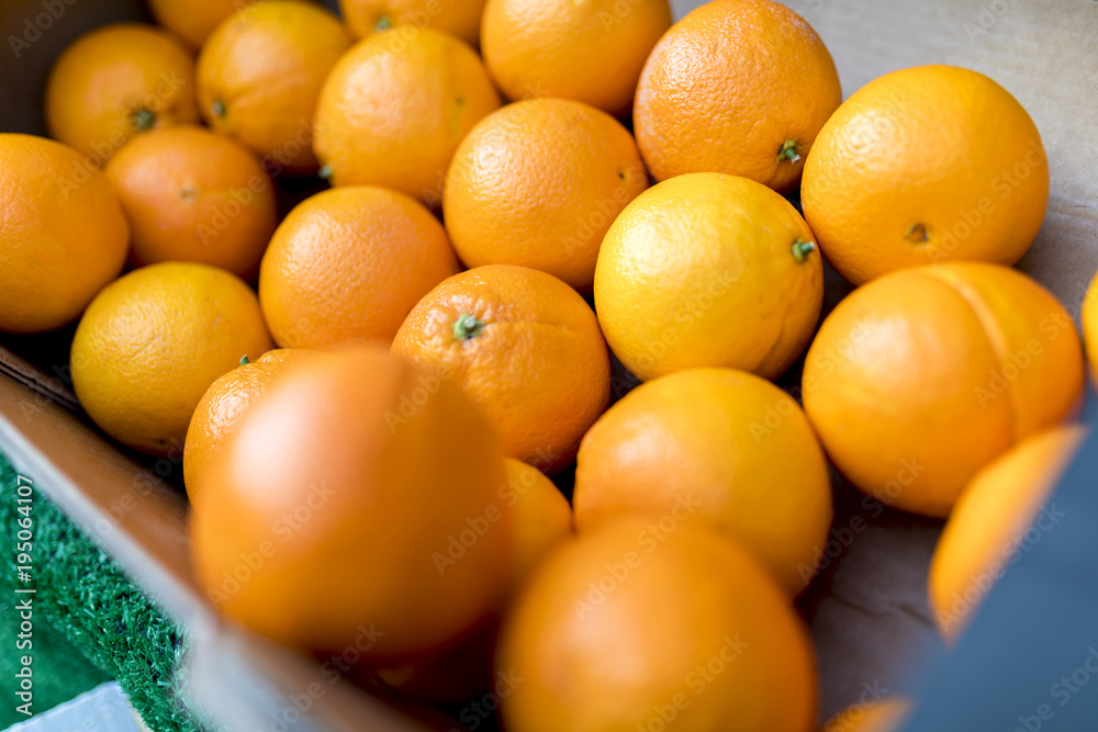 Close up of fresh juicy large Spanish Naval oranges on a traditional market stall in England, UK Close up of fresh juicy large Spanish Naval oranges on a traditional market stall in England, UK