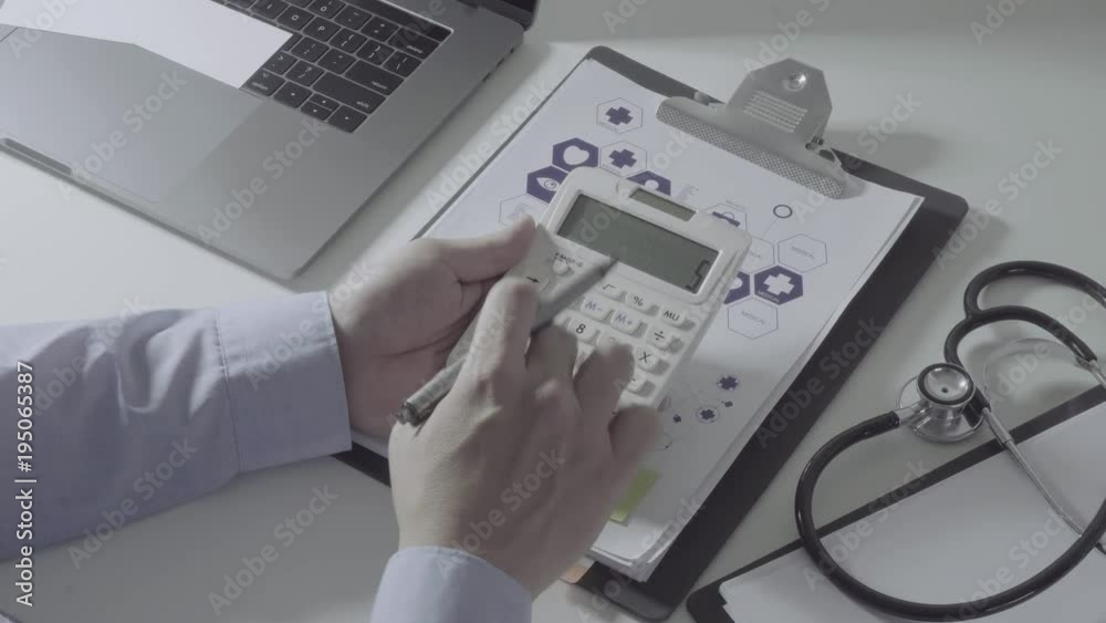 Above view of Healthcare costs and fees concept.Hand of smart doctor used a calculator for medical costs in modern hospital in slow motion
Above view of Healthcare costs and fees concept.Hand of smart doctor used a calculator for medical costs in modern hospital in slow motion