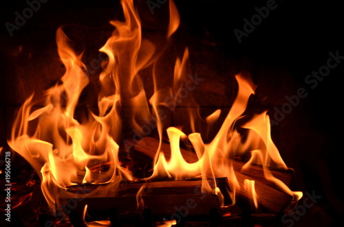 Burning fire in a fireplace with red, orange and yellow flames