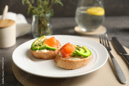 Delicious bruschettas with salmon and avocado on plate