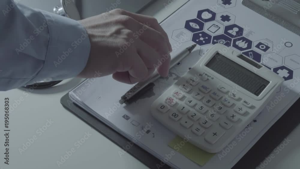 Above view of Healthcare costs and fees concept.Hand of smart doctor used a calculator for medical costs in modern hospital in slow motion
Above view of Healthcare costs and fees concept.Hand of smart doctor used a calculator for medical costs in modern hospital in slow motion