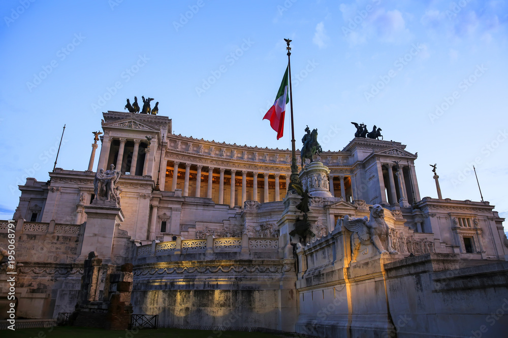 View of Italian national flag in front of Altare della Patria (Altar of the Fatherland) , the equestrian sculpture of Victor Emmanuel