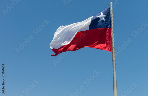 Flag of Chile developing against a clear blue sky
