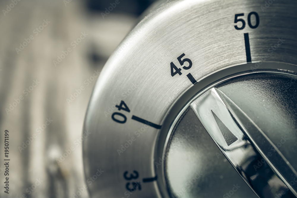 45 Minutes - Three-Quartes Of An Hour - Macro Of An Analog Chrome Kitchen Timer On Wooden Table 45 Minutes - Three-Quartes Of An Hour - Macro Of An Analog Chrome Kitchen Timer On Wooden Table