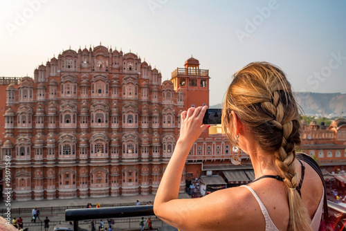 Young woman takes picture of Hawa Mahal in India photo