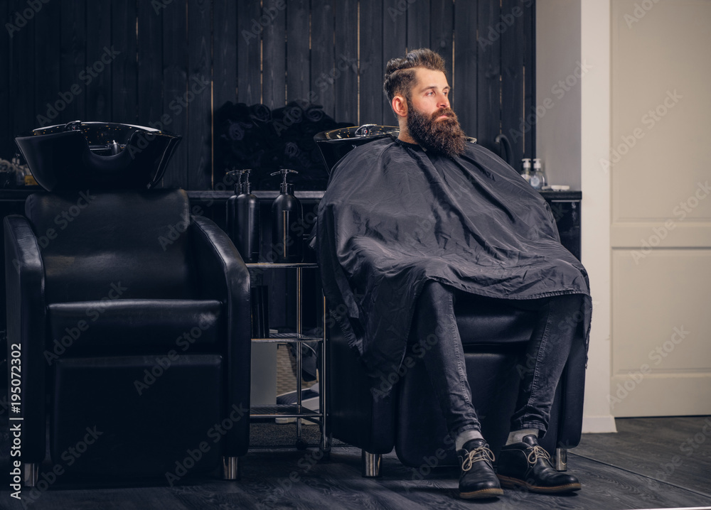 Handsome bearded man in the barbershop.
