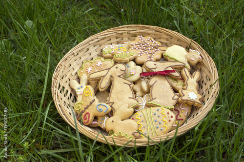 Czech easter gingerbread in wicker basket in the garden, comical bunnies