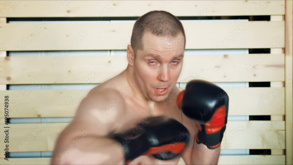 Young male athlete training in boxing gym Young male athlete training in boxing gym