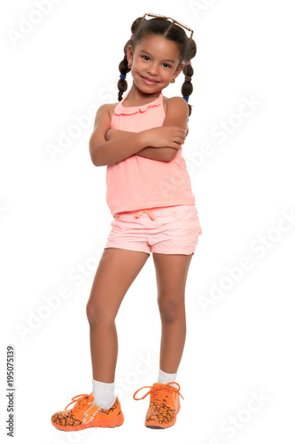 Foto Cute african american girl standing with her arms crossed and smiling